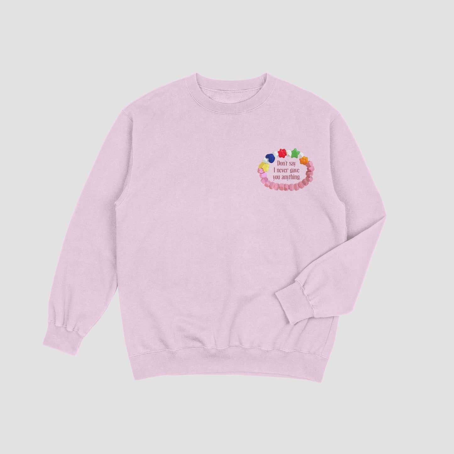 Pink sweatshirt with colorful design on a light gray background