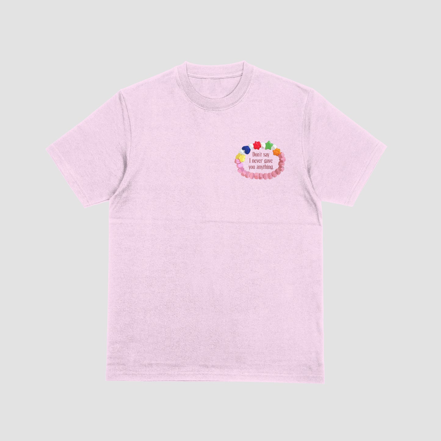 Pink t-shirt with colorful design and text on a light gray background