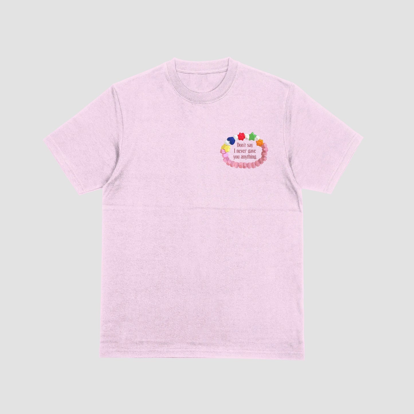 Pink t-shirt with colorful design and text on a light gray background