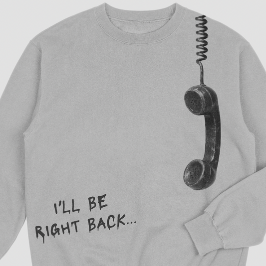 Gray sweatshirt with a phone receiver graphic and text 'I'll be right back...' on a white background