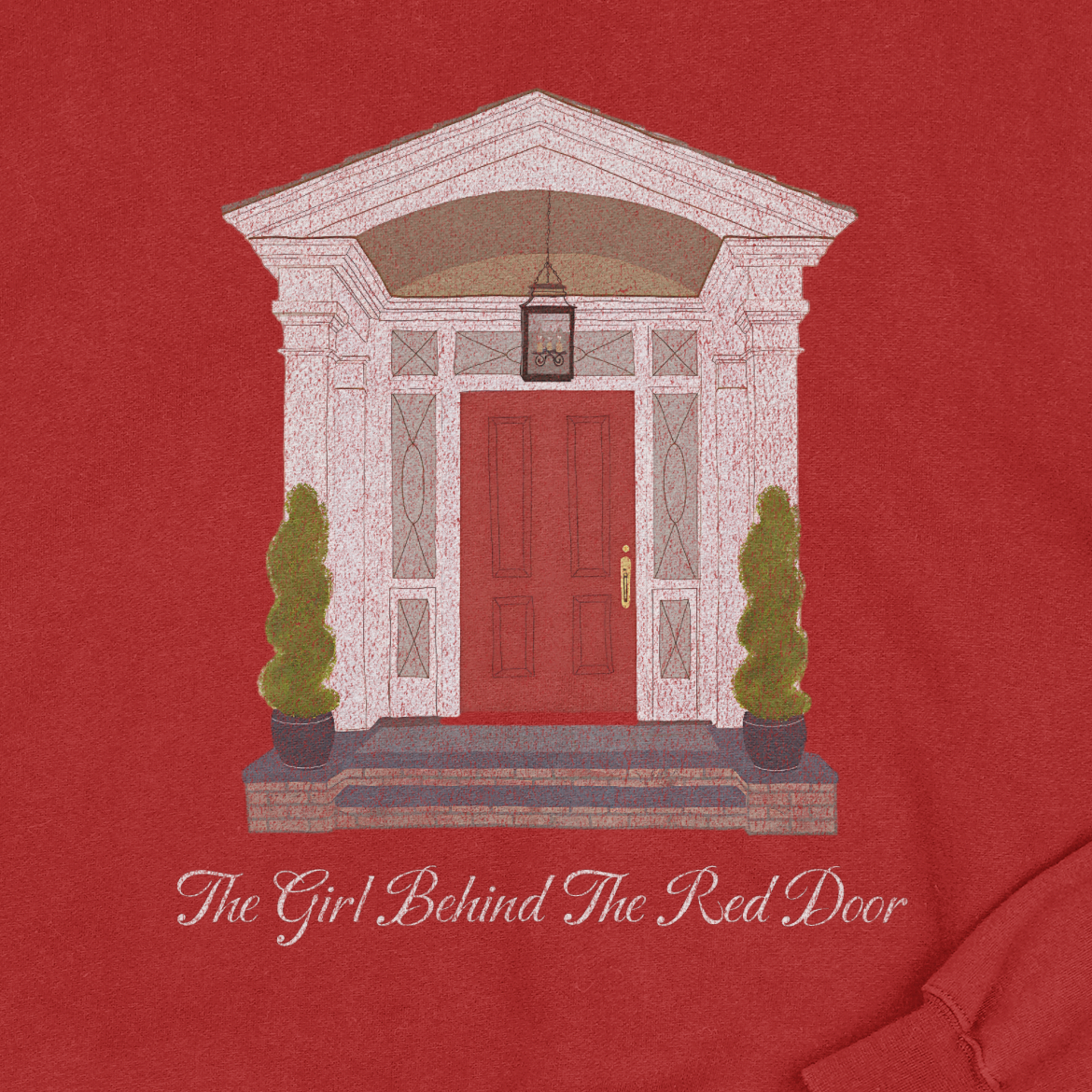 Red shirt with a graphic of a red door and text 'The Girl Behind The Red Door' on a red background