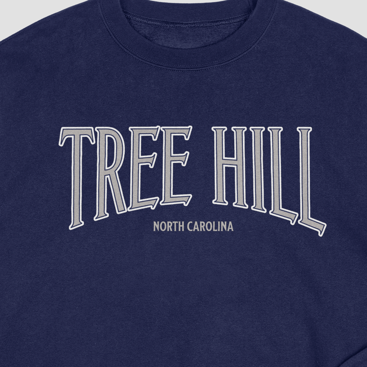 Navy blue sweatshirt with 'Tree Hill North Carolina' text in silver