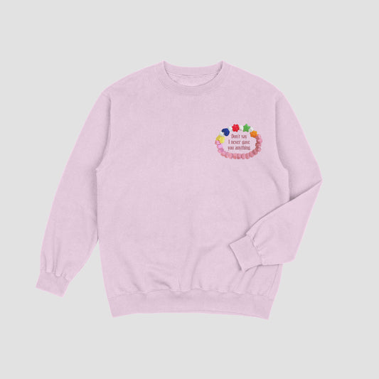 Pink sweatshirt with colorful design on a light gray background