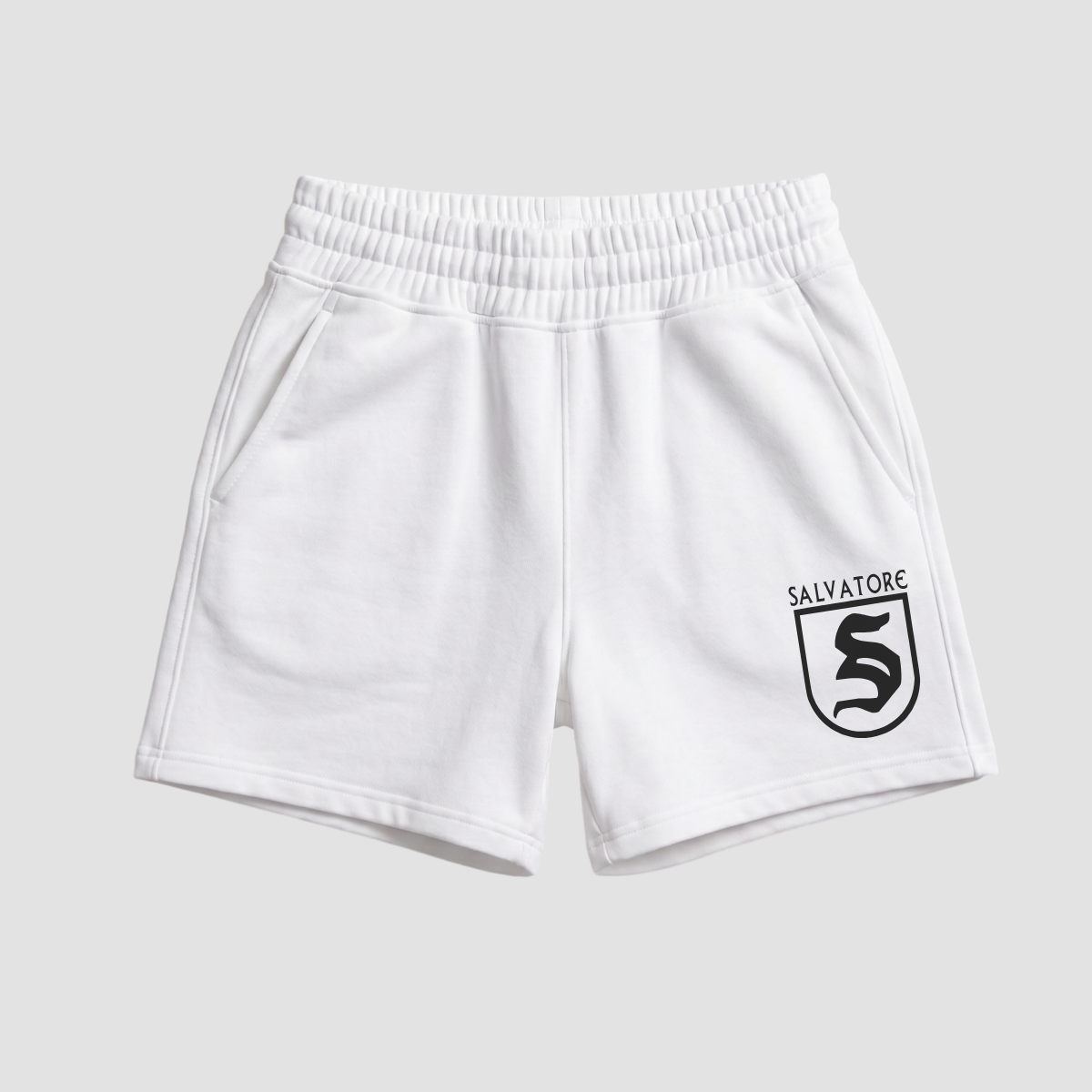 White shorts with a black logo on a light gray background