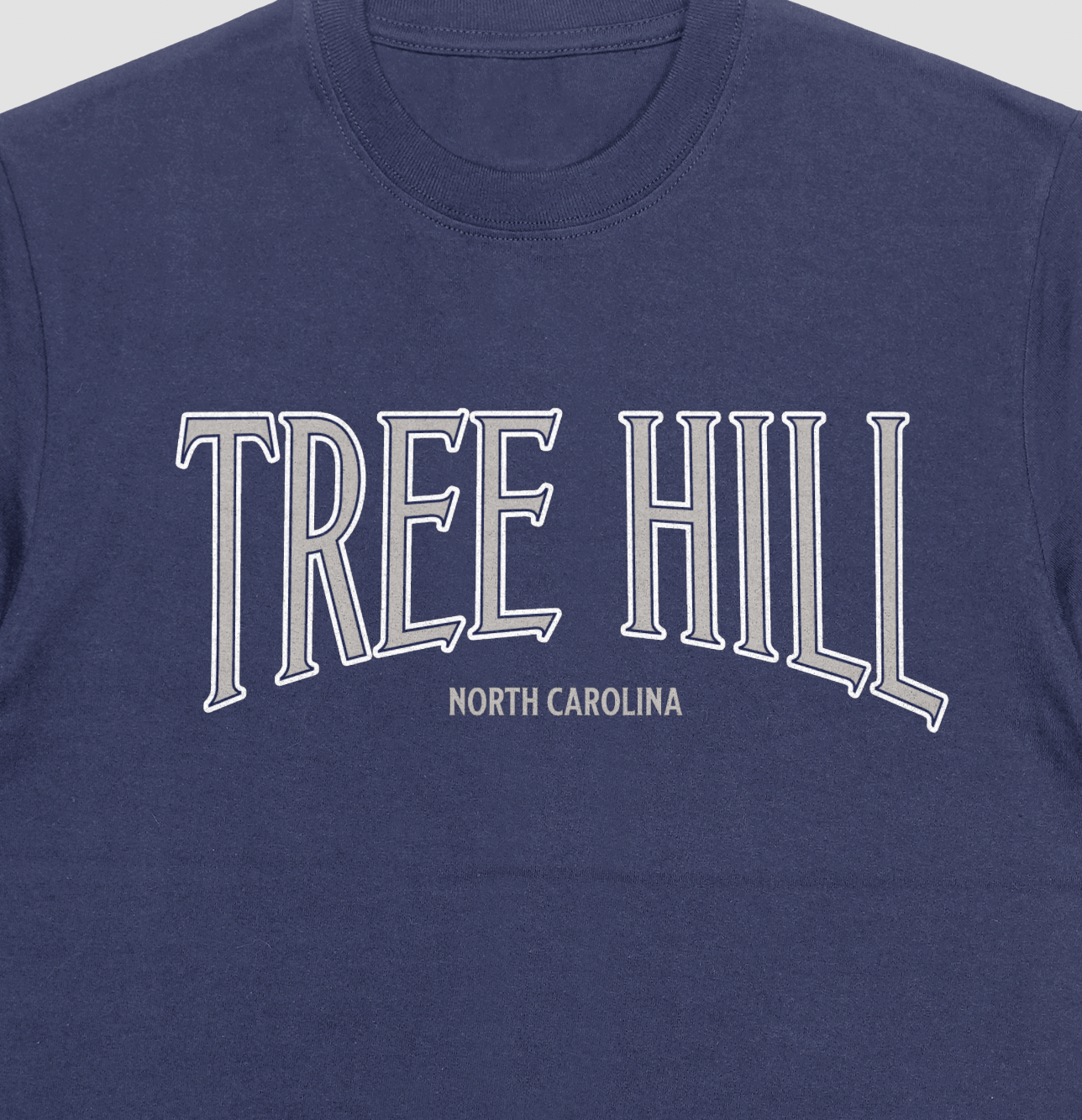 Navy blue t-shirt with 'TREE HILL NORTH CAROLINA' text in silver