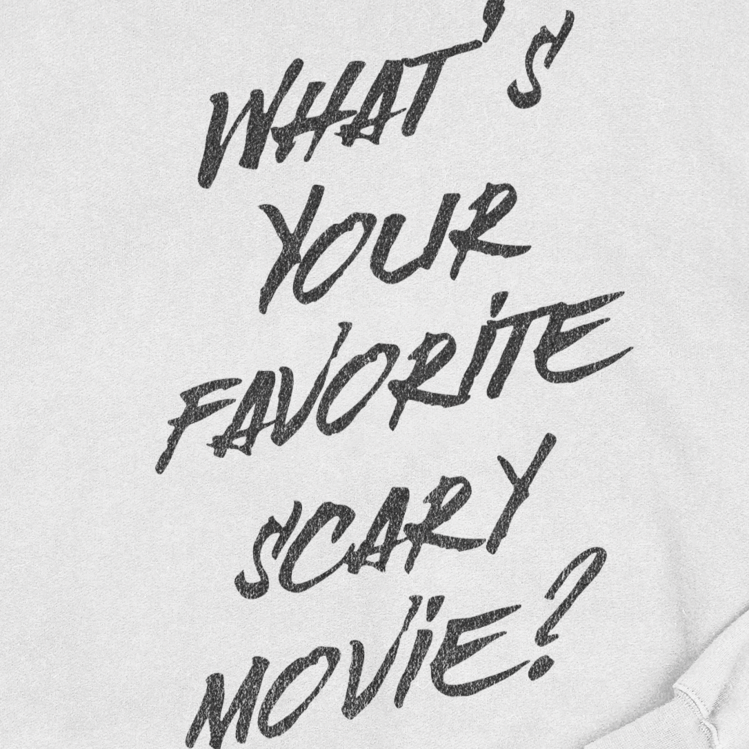 White sweatshirt with black text 'What's your favorite scary movie?'