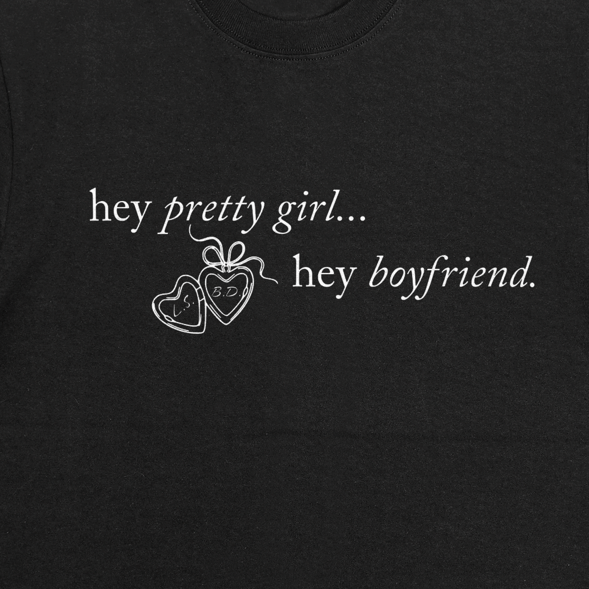 Black t-shirt with white text 'hey pretty girl... hey boyfriend.' and heart designs.