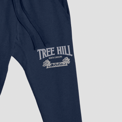 Navy blue sweatpants with 'Tree Hill North Carolina' text and logo on a light gray background