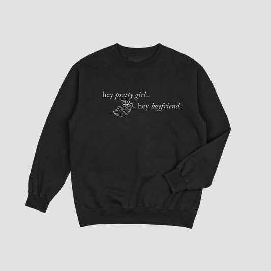 Black sweatshirt with text on a light gray background