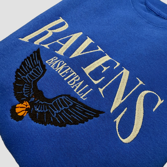 Blue sweatshirt with 'Ravens Basketball' text and eagle logo.
