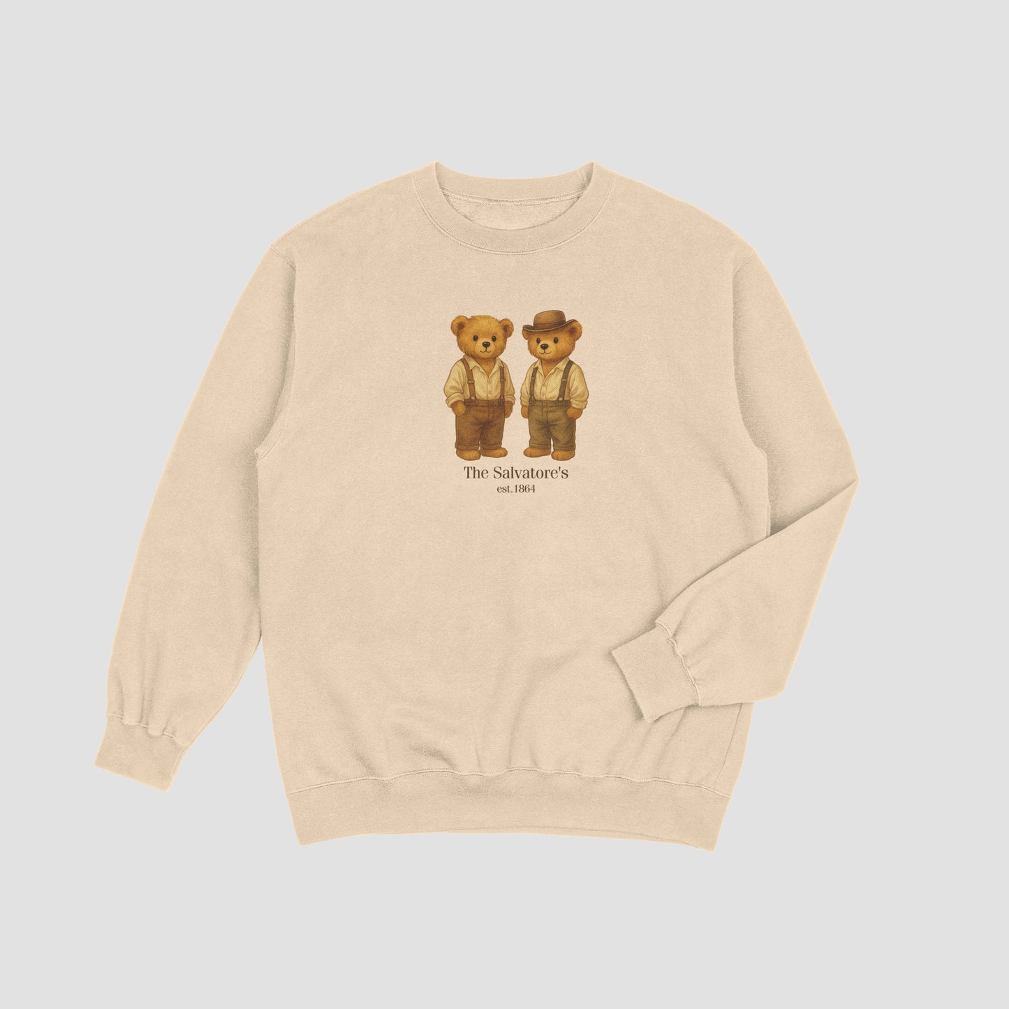 Beige sweatshirt with teddy bear graphic and 'The Salvations' text on a light gray background