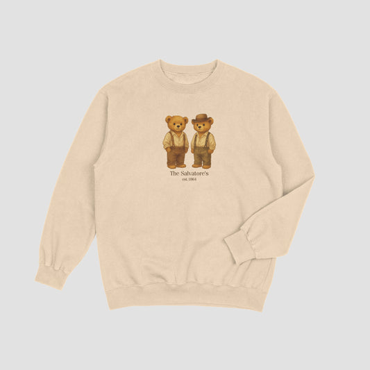 Beige sweatshirt with teddy bear graphic and 'The Salvations' text on a light gray background