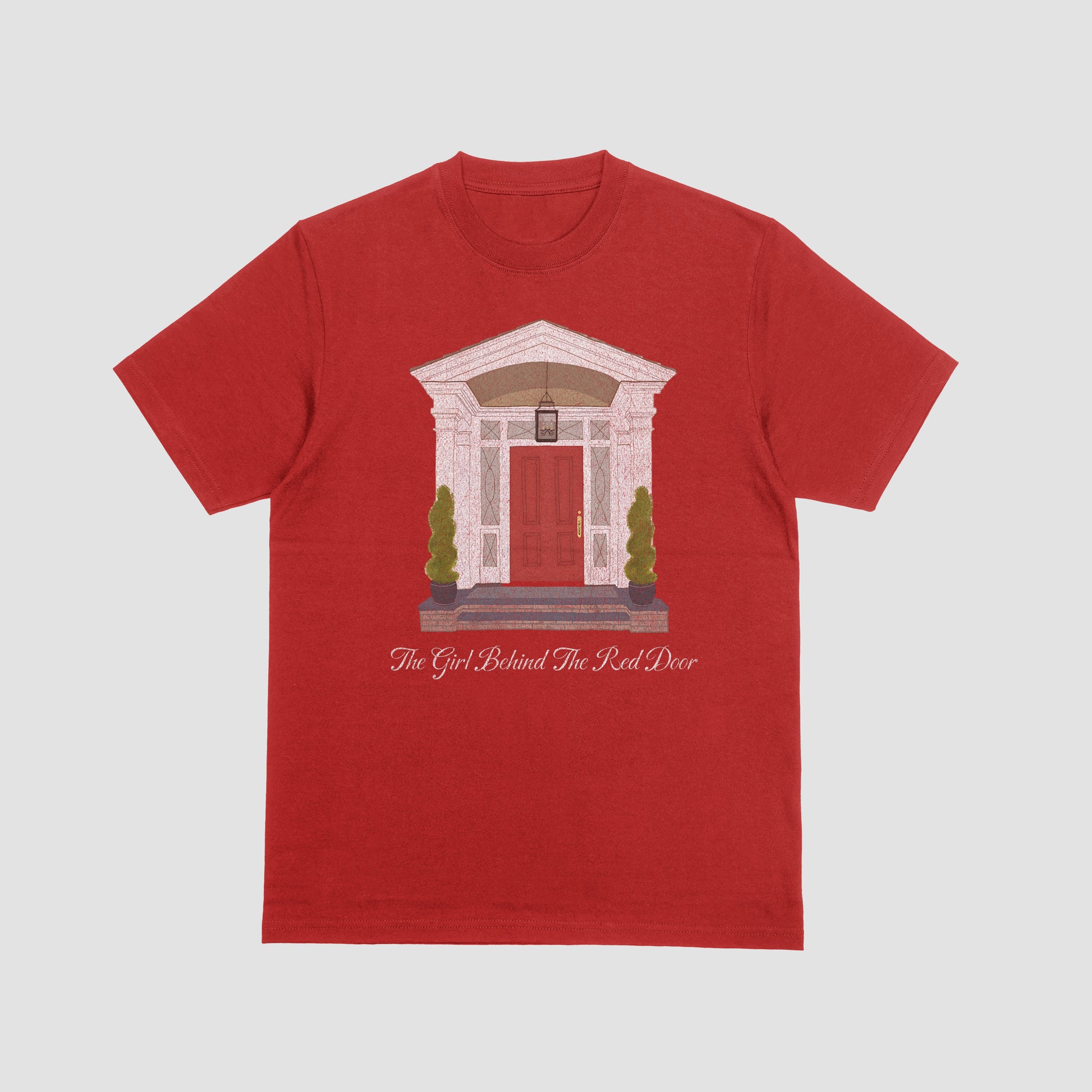 Red t-shirt with architectural design and text on a light gray background