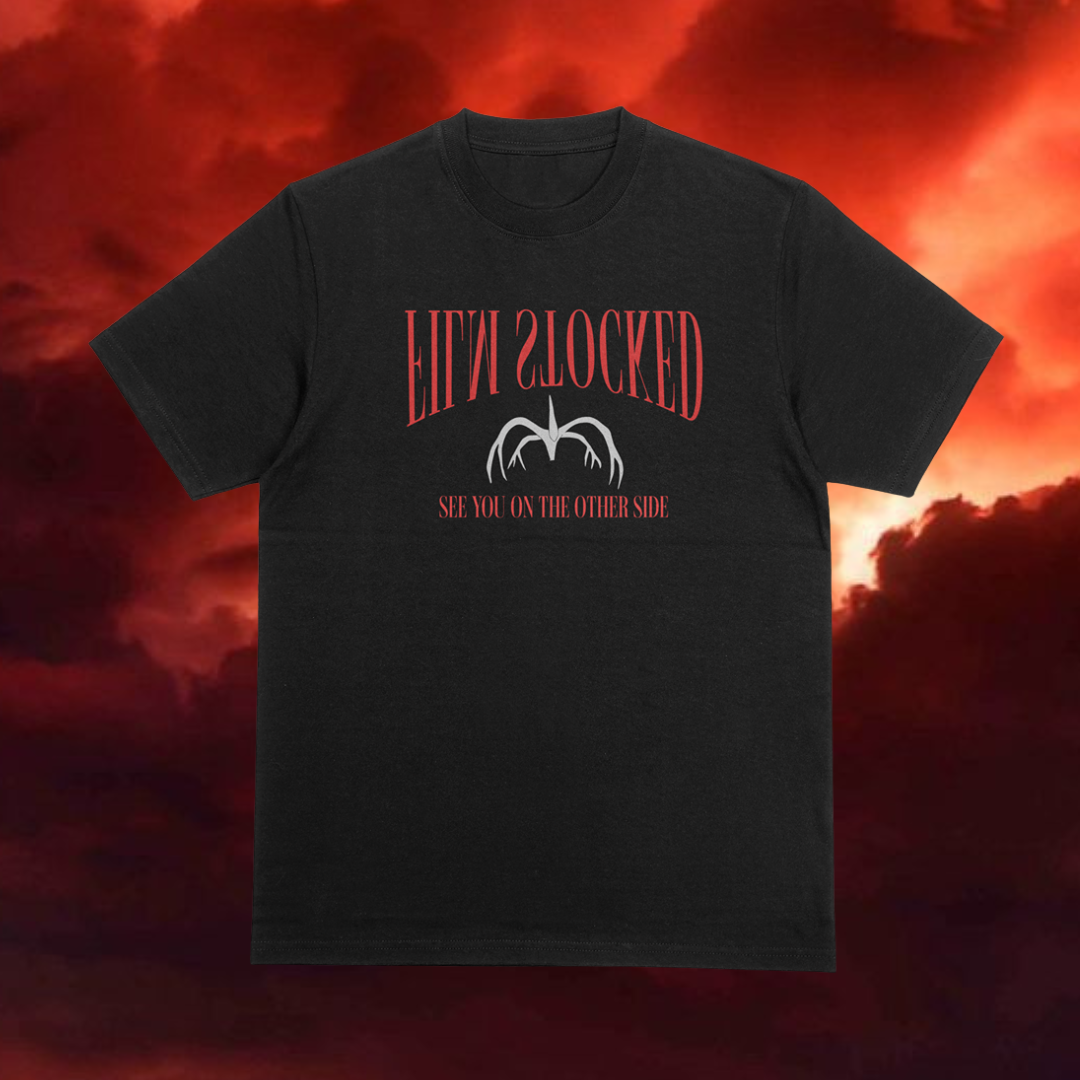 Black t-shirt with red text and graphic on a fiery background